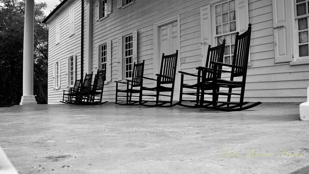 Black and white of rocking chairs on the mansion porch at Hampton Plantation.