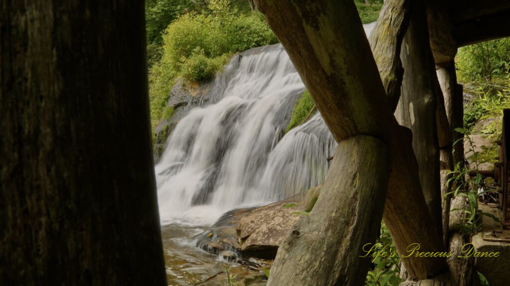 Mill Shoal Falls framed through the wooden posts of a deck.