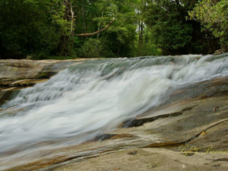 The upper section of Bird Rock Falls rapidly flowing over a rocks.