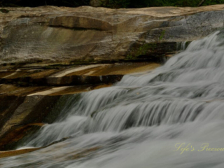 Close up of the upper section of Bird Rock Falls rapidly flowing over a rocks.