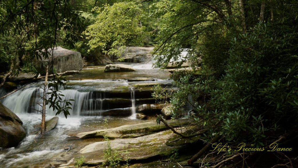 The upper section of Bird Rock Falls flowing over and through the rocks of the French Broad River.