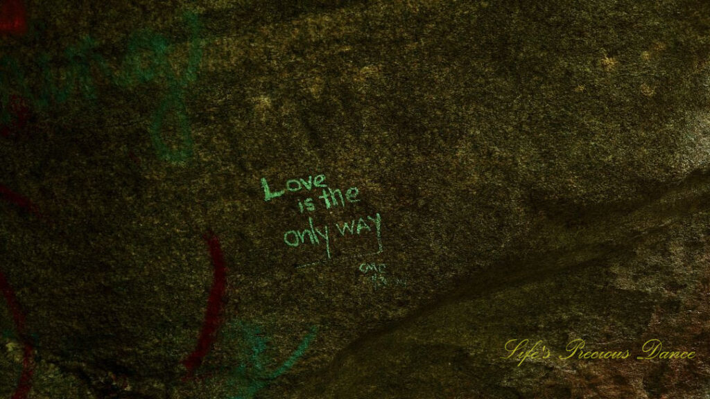 Graffiti on a rock that says &quot;Love is the only way&quot;.