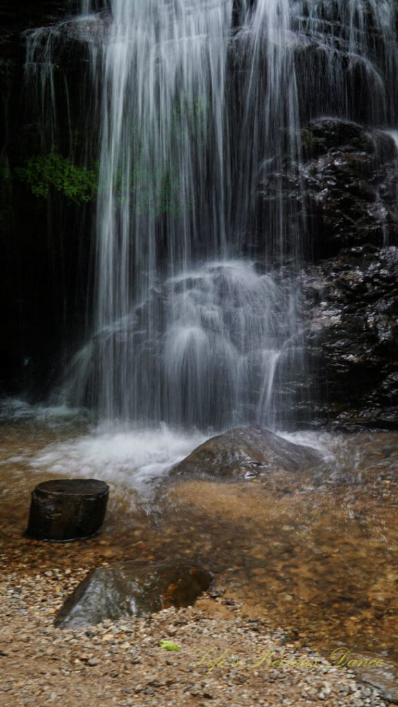 Base of Issaqueena Falls spilling into a pool of water.