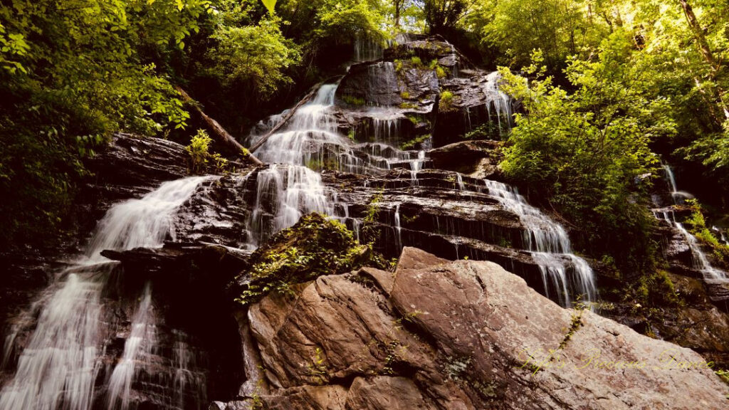 Upward look at Issaqueena Falls spilling down the rockface.