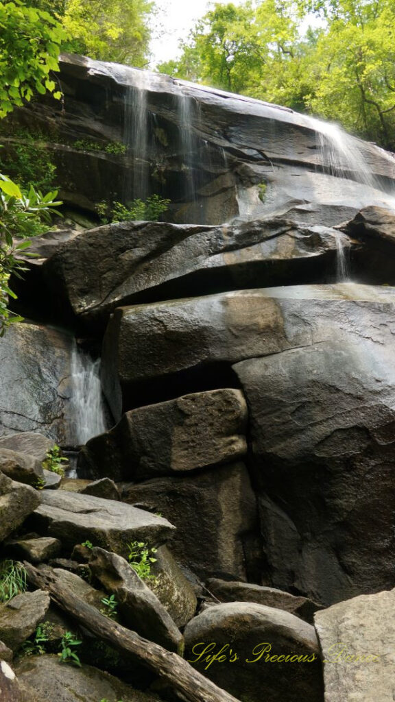 Upper section of Daniel Ridge Falls spilling over the rock ledge and down the boulders.