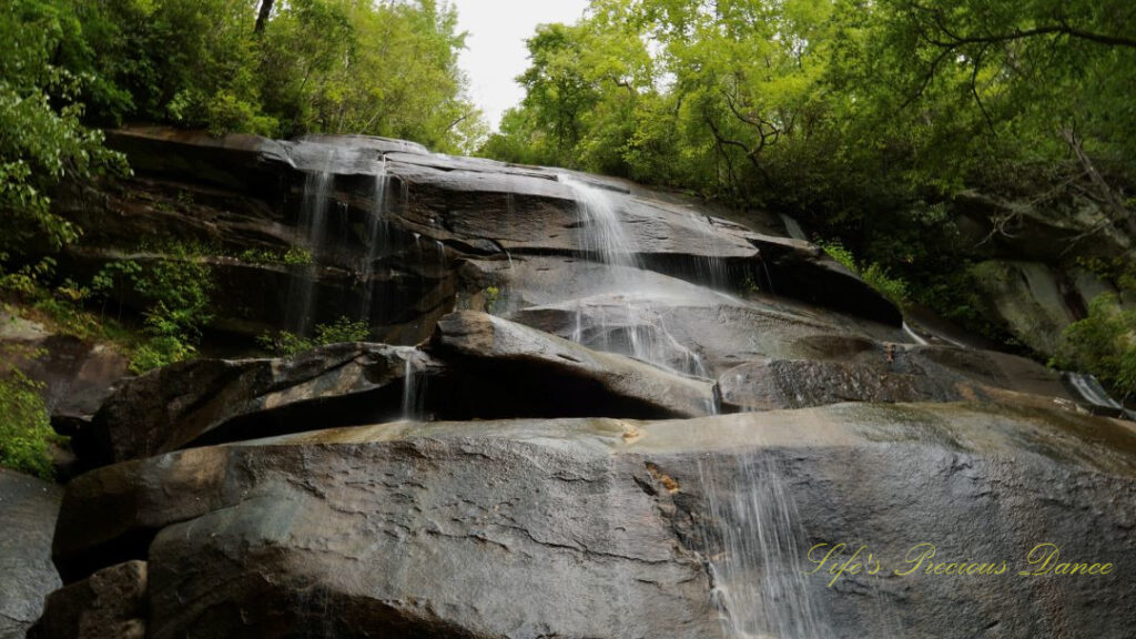 Upper section of Daniel Ridge Falls spilling over the rock ledge and down the boulders.