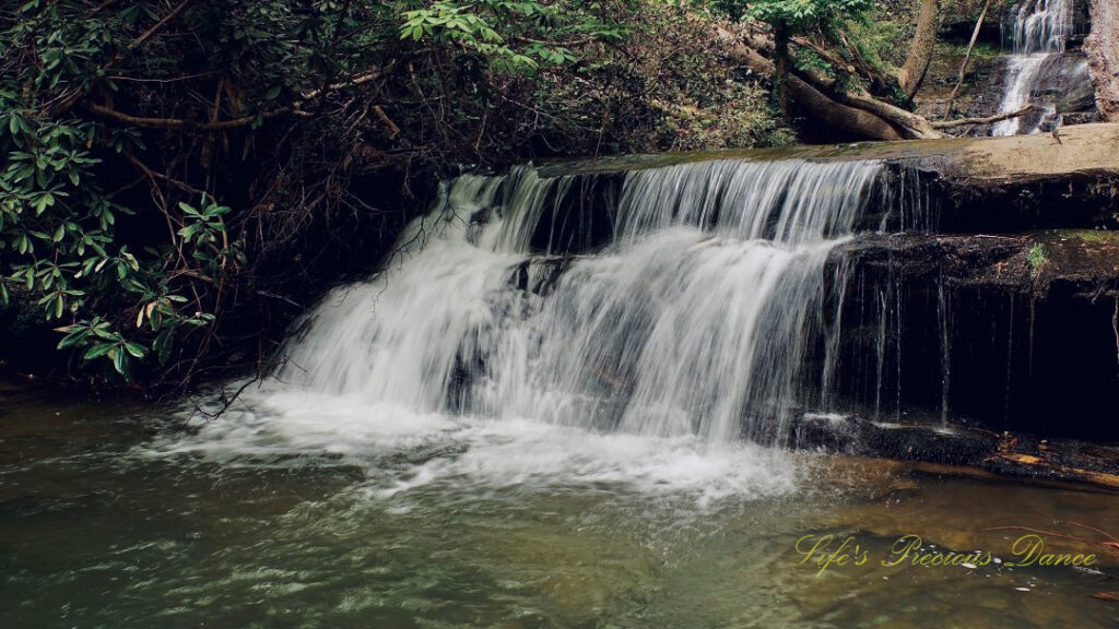 Lower section of Yellow Branch Falls spilling over a rock ledge into the creek.