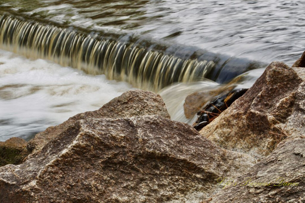 Close up of rushing water spilling over a small ledge at Juniper Creek