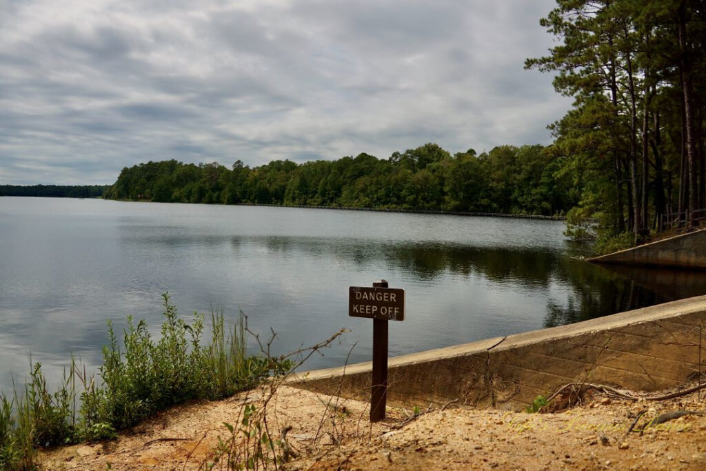 A sign stating &quot;Danger, Keep Off&quot;, in front of the spillway at Lake Juniper