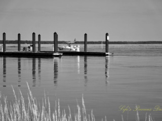Black and white of a fishing boat coming in to dock at Big Bear Creek,