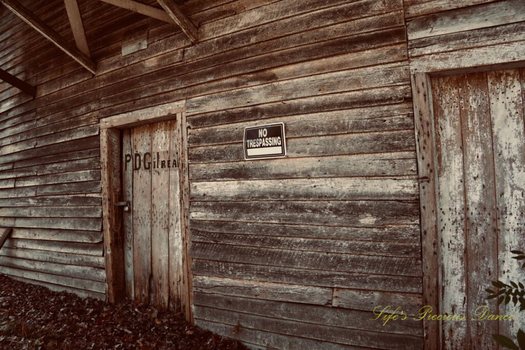 Close up of the front side of Gilreath&#039;s Mill. A sign reads &quot;No Trespassing&quot;.