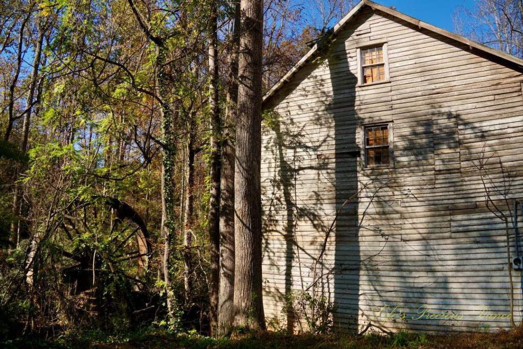 Side view of historic GIlreath&#039;s MIll. The old waterwheel and trees to the right.