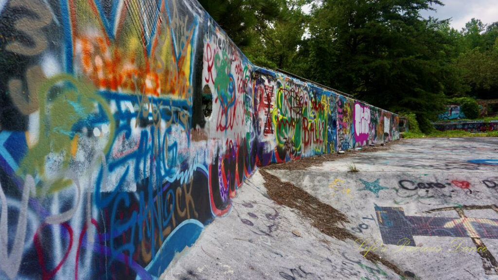 Close up view of graffiti covered wall inside the abandoned Springs Recreation Pool.