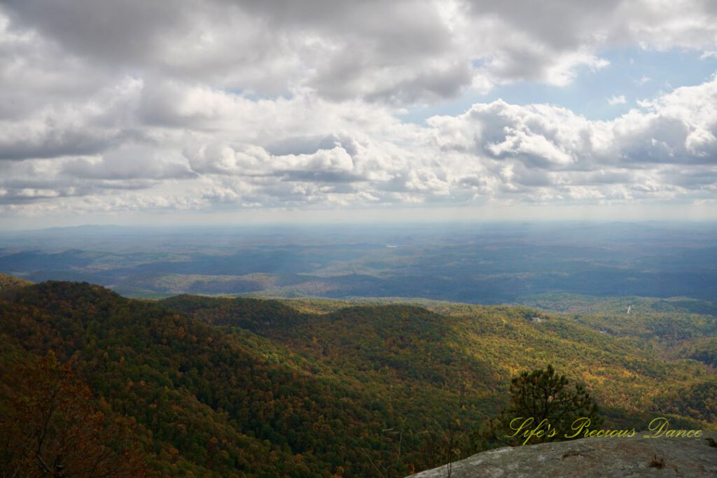 Landscape view from Caesars Head Overlook. The sun&#039;s rays cascading through overhead passing clouds.