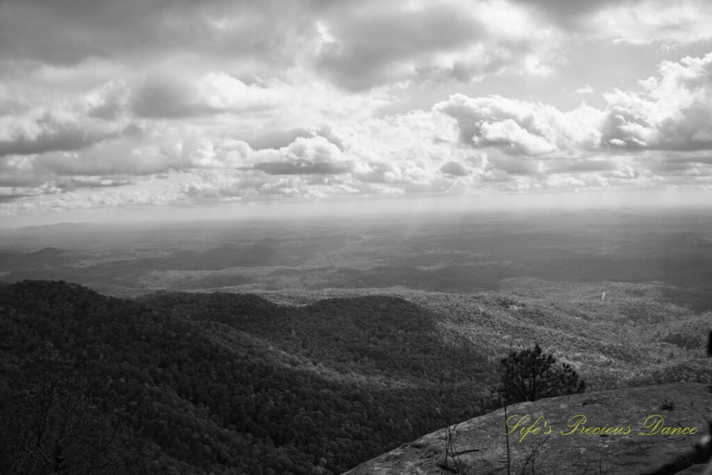 Black and white landscape view from Caesars Head Overlook. Passing clouds overhead.