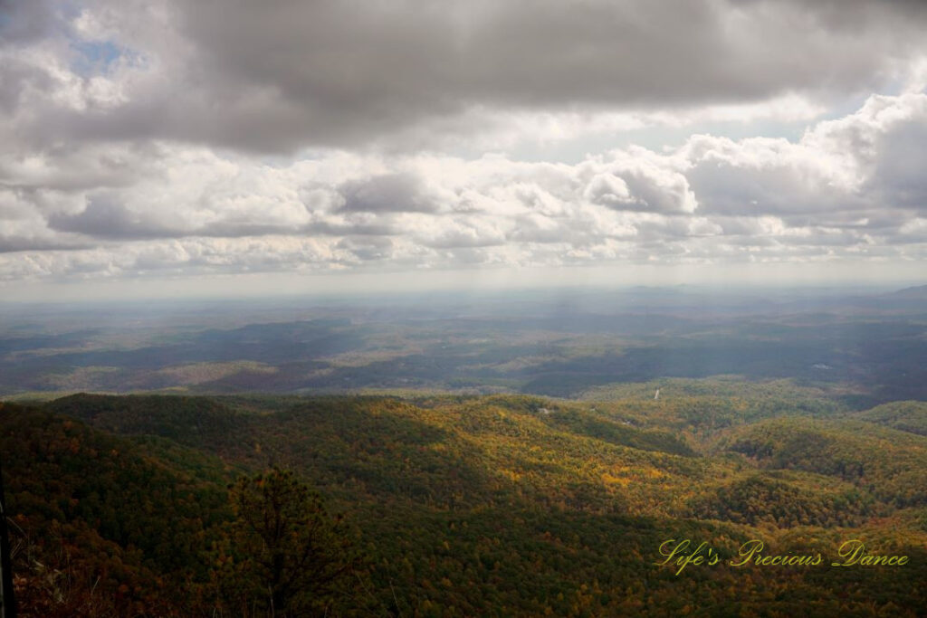 Landscape view from Caesars Head Overlook. The sun&#039;s rays cascading through overhead passing clouds.