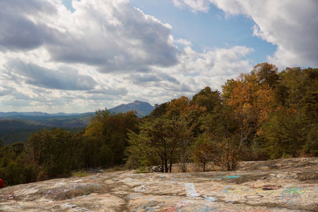 Landscape view from the top of Bald Rock, featuring the peak of Table Rock with passing clouds overhead.