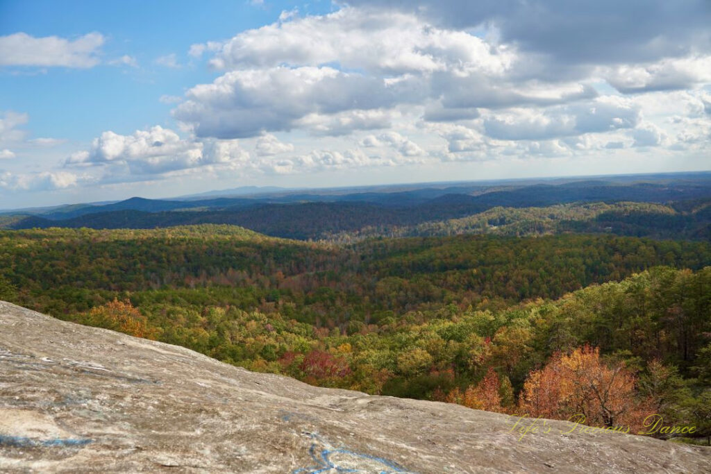 Landscape view from Bald Rock looking outward at mountain ranges and valleys. Passing clouds overhead.