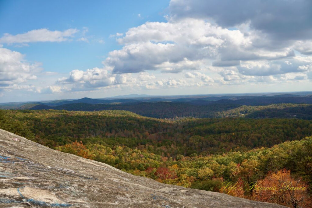 Landscape view from Bald Rock looking outward at mountain ranges and valleys. Passing clouds overhead.