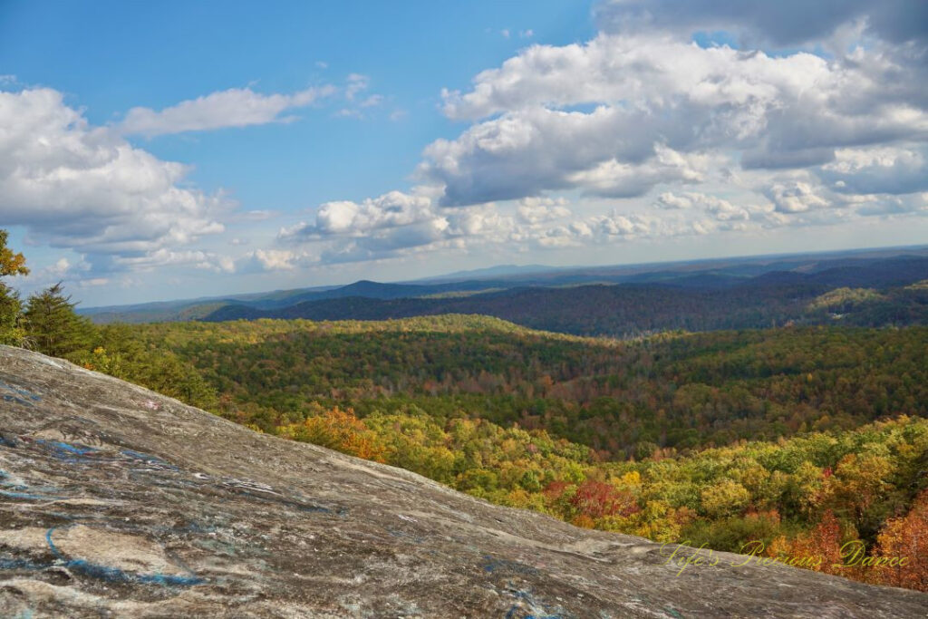 Landscape view from Bald Rock looking outward at mountain ranges and valleys. Passing clouds overhead.