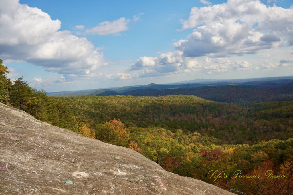 Landscape view from Bald Rock looking outward at mountain ranges and valleys. Passing clouds overhead.