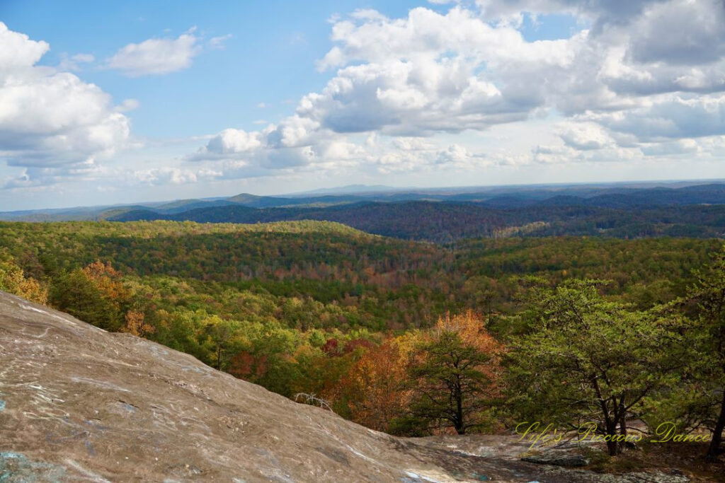 Landscape view from Bald Rock looking outward at mountain ranges and valleys. Passing clouds overhead.