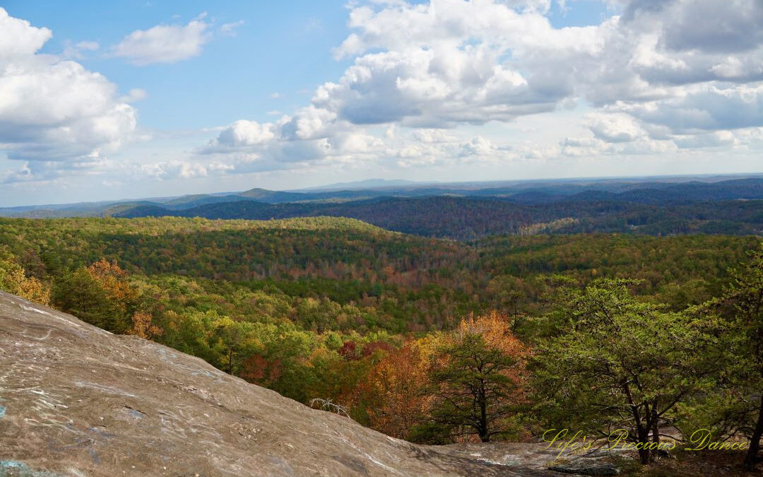 Landscape view from Bald Rock looking outward at mountain ranges and valleys. Passing clouds overhead.