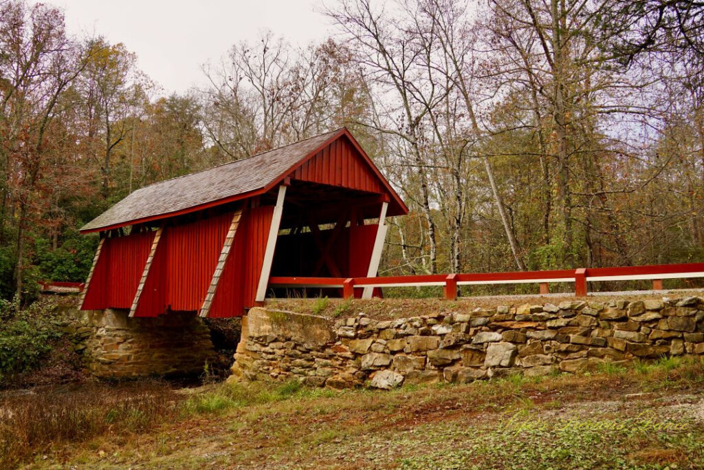 Front and side view of Campbell&#039;s Covered Bridge spanning the creek.