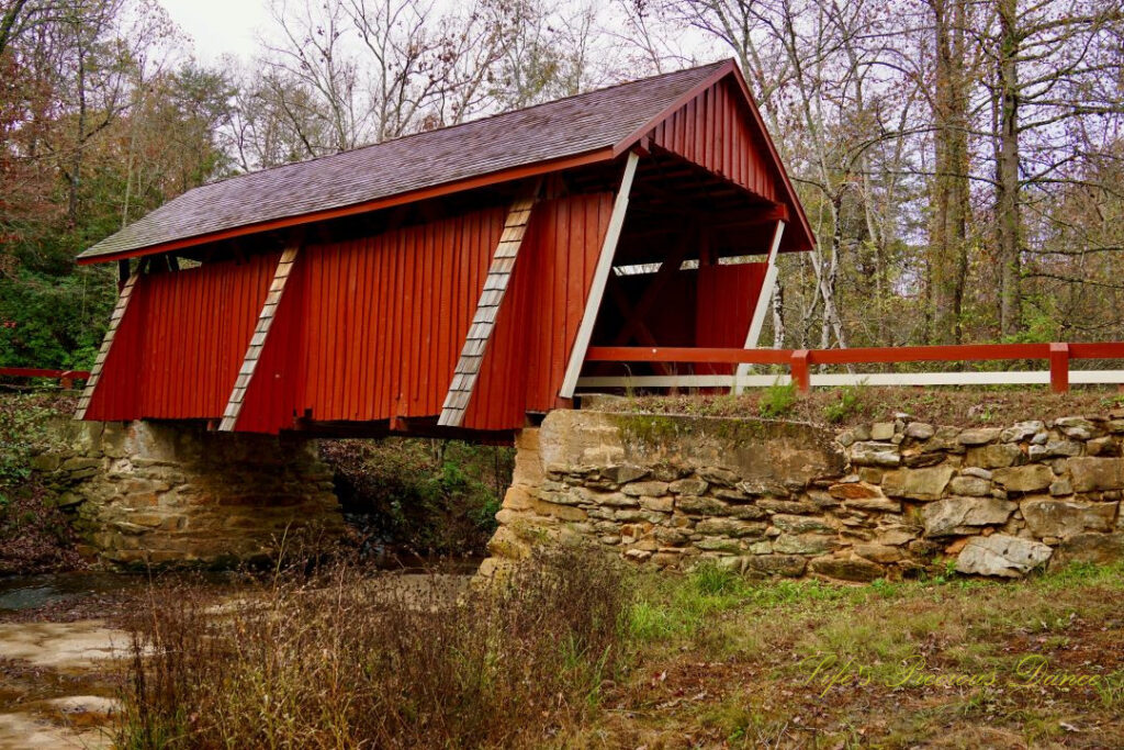 Front and side view of Campbell&#039;s Covered Bridge spanning the creek.