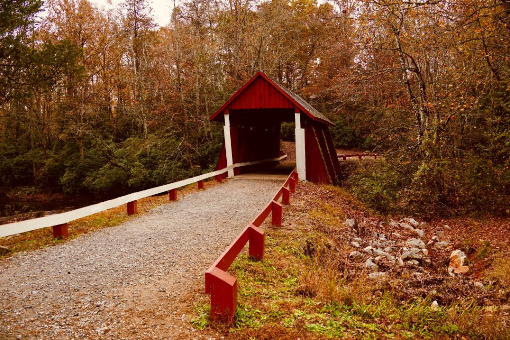 Front view of Campbell&#039;s Covered Bridge. Colorful trees in the background.