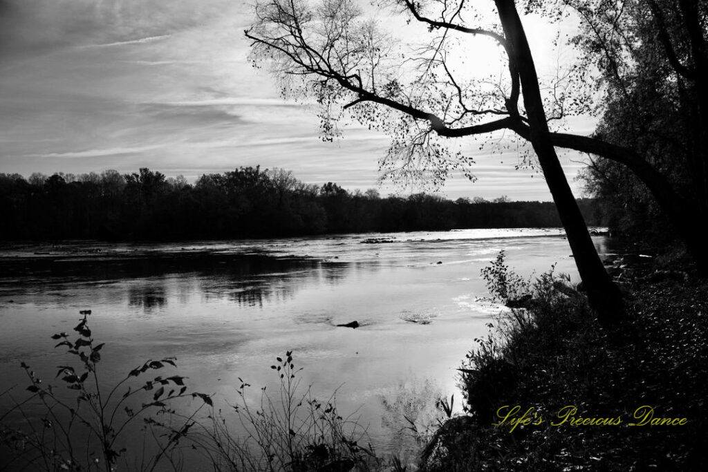 Black and white view of the Catawba River. Passing clouds overhead.